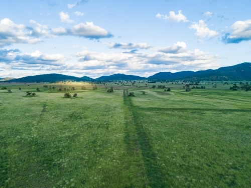 Trail through green farm paddocks - Australian Stock Image