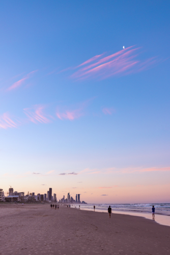 Tranquil beach afternoon with view of the Gold Coast city skyline at dusk - Australian Stock Image