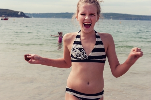 tween girl running towards camera, crazy laughing - Australian Stock Image