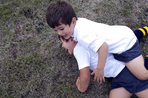Two boys tackling during a football game - Australian Stock Image