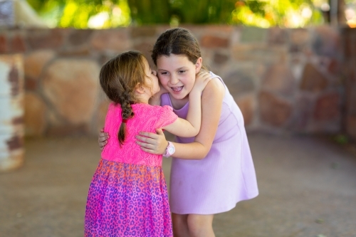 two female girls whispering and smiling - Australian Stock Image