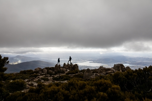 Two figures on a mountain top in the clouds