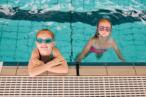 Two girls looking up from a pool - Australian Stock Image