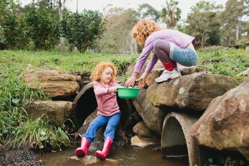 Two girls playing near a stormwater drain - Australian Stock Image