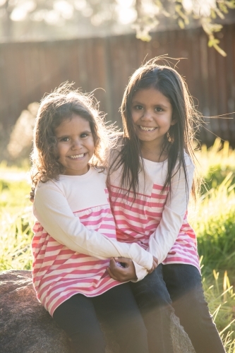 Two happy Aboriginal girl sisters - Australian Stock Image