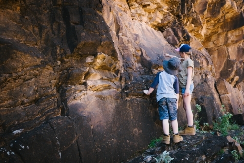 Two kids inspecting rocks during a trek through the Flinders Ranges