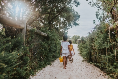 two little girls walking to the beach - Australian Stock Image