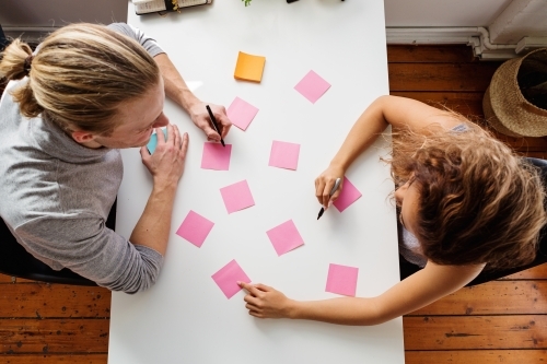 Two people working on a planning session from above - Australian Stock Image