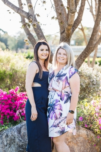 Two sisters standing together smiling - Australian Stock Image