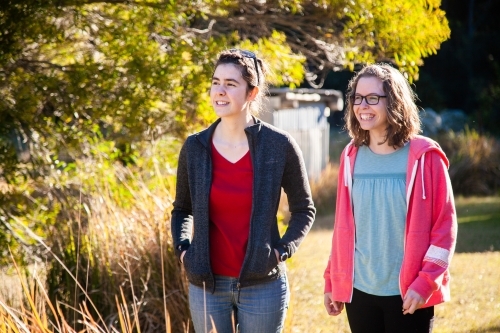 Two teen friends standing together outside in winter - Australian Stock Image