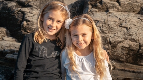 Two young sisters portrait at the beach - Australian Stock Image