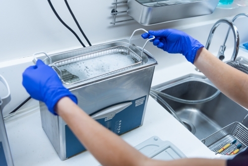 Ultrasonic cleaner used to clean dental instruments - Australian Stock Image