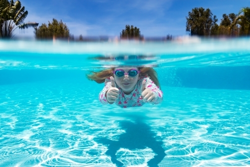 Under water shot of young girl swimming - Australian Stock Image