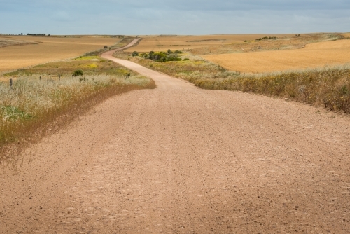 Unsealed road through regional area - Australian Stock Image