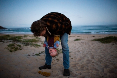 Upside down baby at the beach with dad - Australian Stock Image