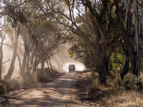 Vehicle travelling along a dusty dirt road - Australian Stock Image