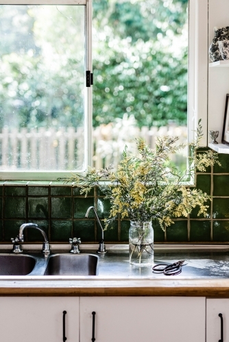 Vertical shot of a yellow plant prepared in the kitchen sink