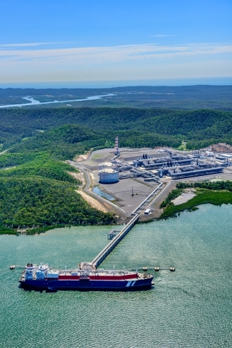 Vertical shot of  liquified natural gas plant and LNG ship on Curtis Island, Queensland - Australian Stock Image