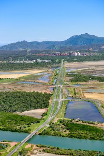 Vertical shot of road leading to industrial sites near Gladstone - Australian Stock Image