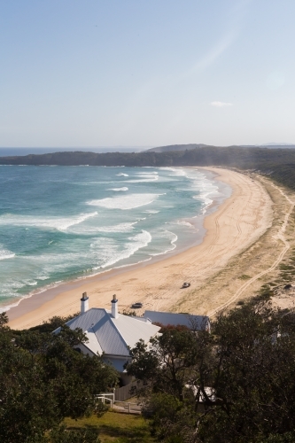 View from Sugar loaf point over lighthouse beach where people are four wheel driving - Australian Stock Image