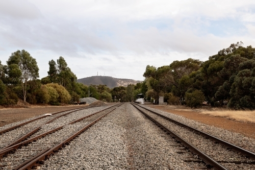 View looking along railway tracks leading out of country town - Australian Stock Image