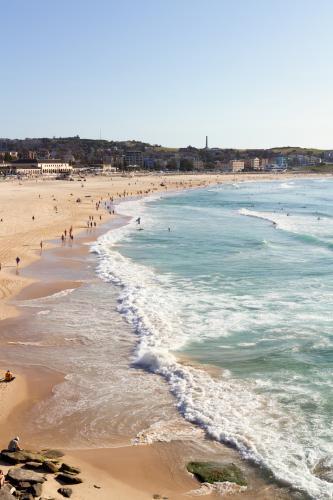 View of Bondi Beach from Bondi Baths on a clear summer day - Australian Stock Image