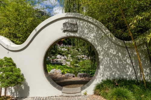 view of garden through circular gateway - Australian Stock Image