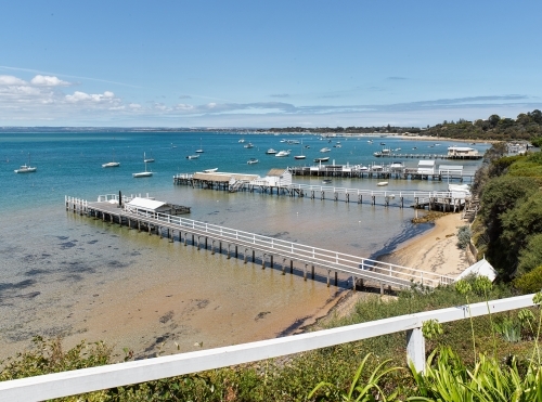 view of jetties & boatsheds from cliffside walk - Australian Stock Image