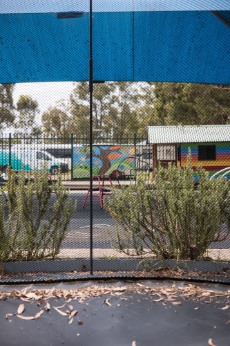 View of preschool yard from inside trampoline - Australian Stock Image