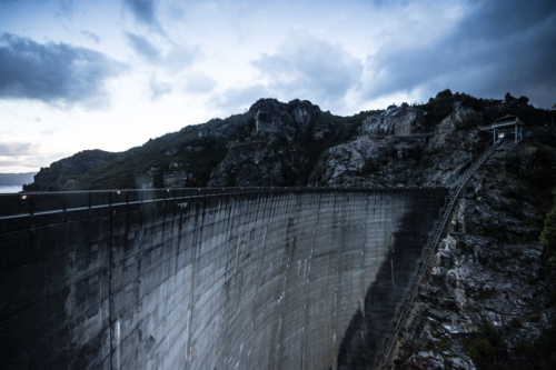 View of the Gordon Dam on a cool summer's day. It is a unique double curvature concrete arch dam - Australian Stock Image