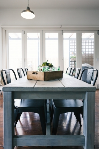 Vintage bottle crate decor in an industrial styled dining room - Australian Stock Image