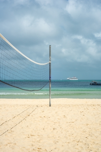 Volleyball net on empty beach - Australian Stock Image