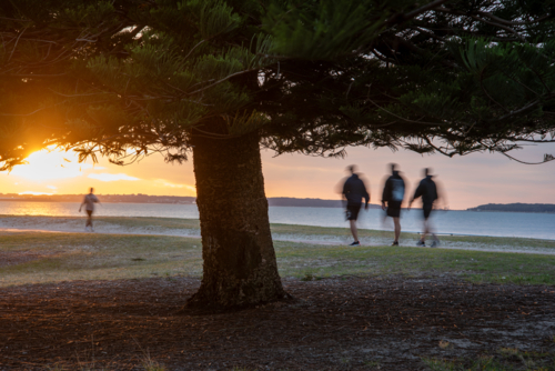 Walkers at sunrise by Botany Bay - Australian Stock Image