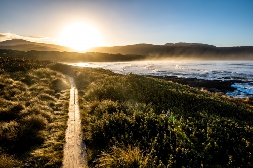 walking path beside the beach at sunrise - Australian Stock Image