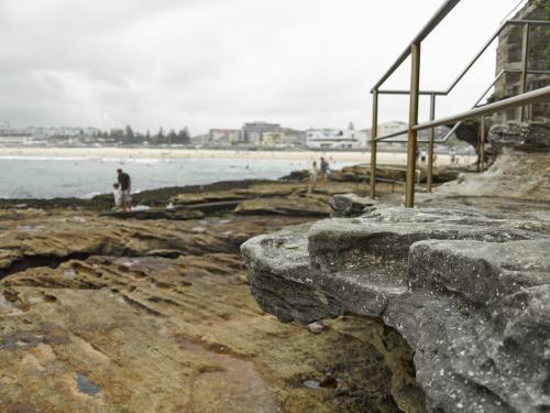 Walking track over rocks at Bondi on an overcast day - Australian Stock Image