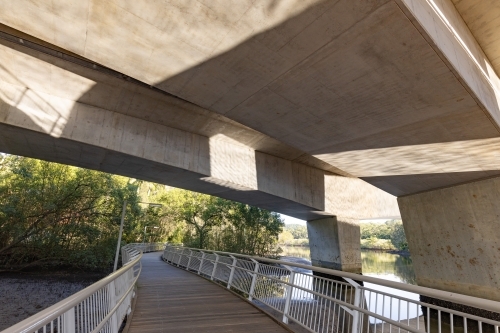 Walkway under motorway bridge crossing the Brunswick River - Australian Stock Image