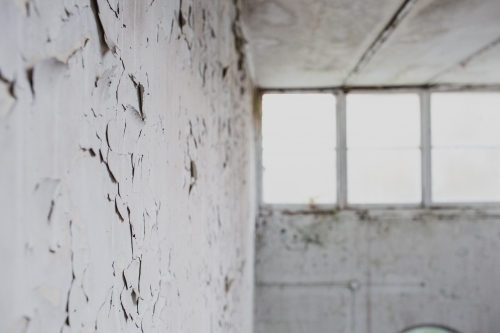 warehouse window in derelict apartment lobby - Australian Stock Image