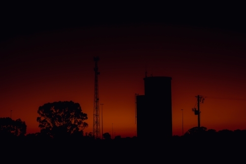 Water and telecommunications towers silhouette at sunset - Australian Stock Image