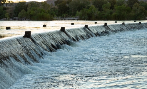 water cascading over the roadway at Ivanhoe Crossing near Kununurra - Australian Stock Image
