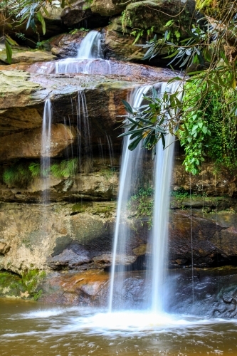 Water flowing over rocky waterfall - Australian Stock Image