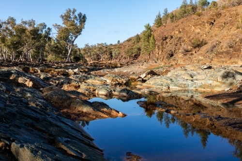 water in gum lined outback creek - Australian Stock Image