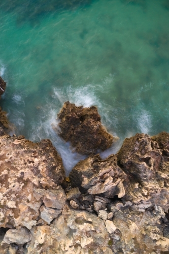 Wave on limestone cliff long exposure from above, at the Henderson Cliffs. - Australian Stock Image