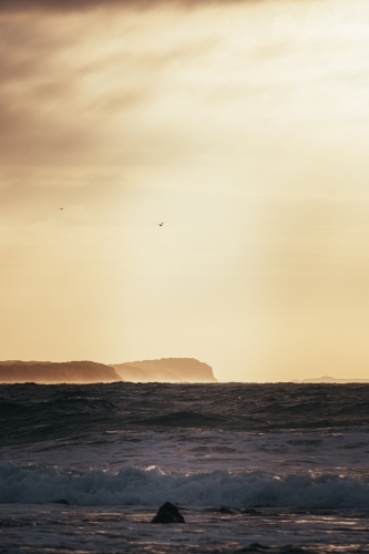 Waves, Cliffs, and a Cloudy Sunrise - Australian Stock Image