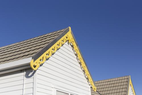 Weatherboard house with yellow trim - Australian Stock Image