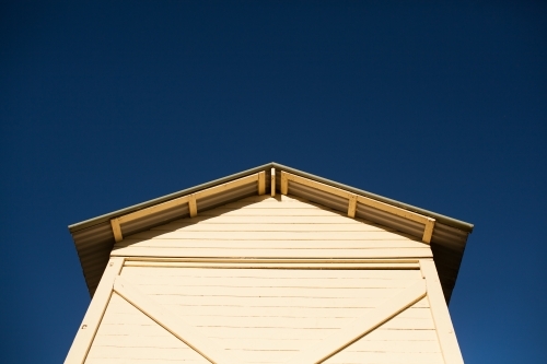 Weatherboard hut against a bright blue sky - Australian Stock Image