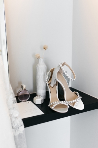 Wedding bride details of shoes, rings and perfume - Australian Stock Image