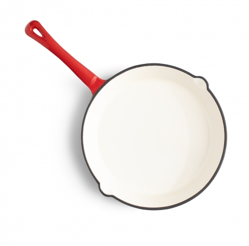 white and red frying pan on white background - Australian Stock Image