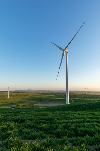 wind tower with wind farm in distance - vertical - Australian Stock Image