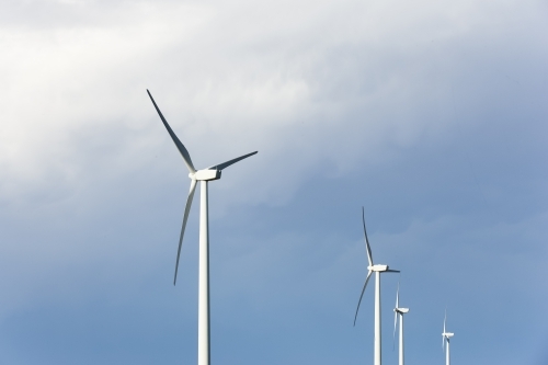 Wind turbines against a stormy sky - Australian Stock Image