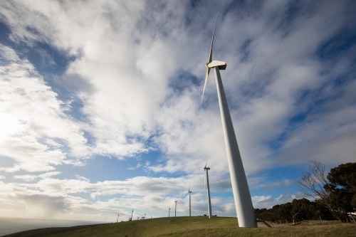 Wind turbines on a bare grassy hill exposed to offshore winds on the Fleurieu Peninsula - Australian Stock Image